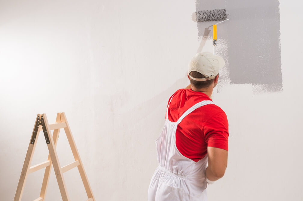 A Painters Applecross painting a wall with full dedication